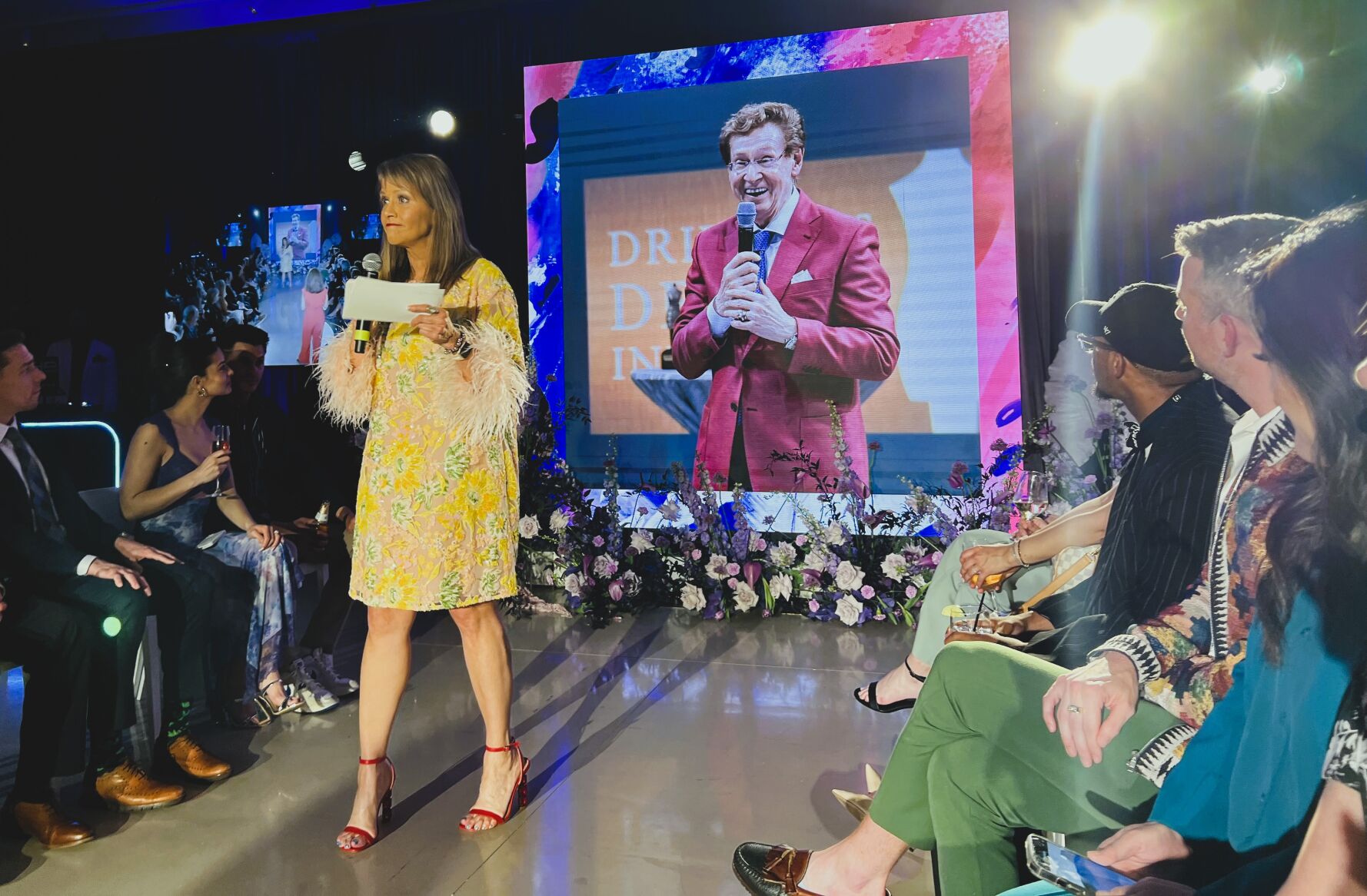 Co-emcees Sylvia Perez and Linda Yu open the Driehaus Fashion Awards with a moving video of its late founder Richard Driehaus. (Photo Candace Jordan)
